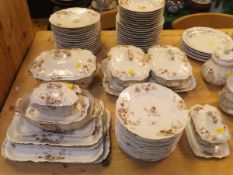 A Limoges porcelain part dinner service decorated with floral sprays in grey,