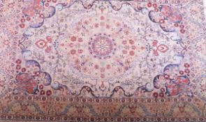 An Indian/Persian design rug, the central floral medallion in pale green, terracotta,