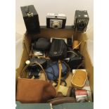 A box of vintage cameras and camera equipment to include box Brownie, a Kodak Brownie 127,