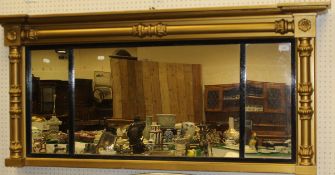 A 19th Century gold framed wall mirror with acanthus topped column decoration and ebonised slips