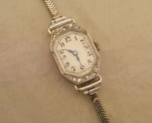 An 18 carat white gold cased cocktail watch, set with diamonds to the outside,