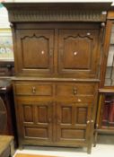 A 19th Century oak cupboard of two doors above two drawers and two cupboard doors,