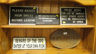 A collection of five reproduction cast iron signs to include "Antiques", "No licquor served ...