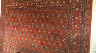 A pair of Persian style rugs with floral and foliate design in pale gold,