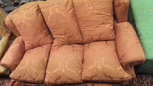 An early to mid 20th Century three-seat scroll arm sofa upholstered in terracotta damask fabric