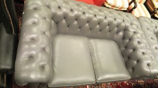 Two modern two-seat Chesterfield sofas in light grey leatherette upholstery,