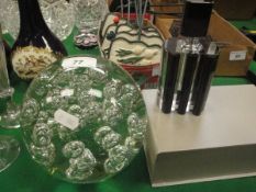 A large glass dump paperweight / doorstop with internal bubble decoration,