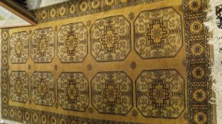 An Afghan rug, the ten central elephant foot medallions in pale gold,