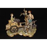 A large capo-di-monte figure group of a grape picker with donkey and boy in cart,