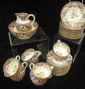 A collection of early 20th Century porcelain tea wares decorated in iron red,