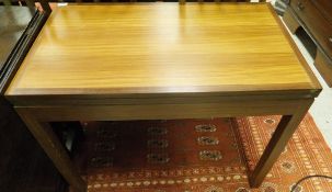 A 20th Century G Plan teak rectangular fold-over card table on square supports