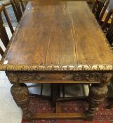 An oak refectory style dining table with heavily carved frieze,