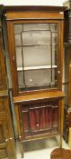 A mahogany and satinwood cross banded display cabinet with astragal glazed door enclosing three