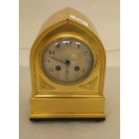 A brass cased mantel clock of lancet form,