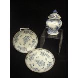 A pair of 19th Century Delft blue and white shallow bowls decorated with floral sprays,