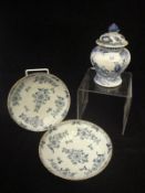 A pair of 19th Century Delft blue and white shallow bowls decorated with floral sprays,