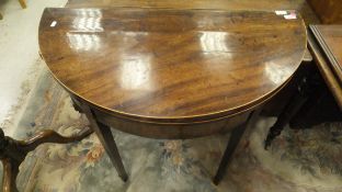 An early 19th Century mahogany tea table of demi-lune form,