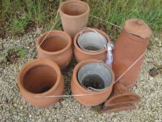 A selection of Teracotta garden pots comprising a set of four, a rhubarb forcer,