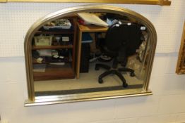 A modern overmantle mirror with silvered effect frame