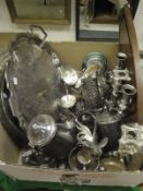 A box of assorted plated wares to include a twin-handled tray, goblets, various candlesticks,