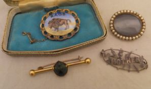 A Victorian yellow metal brooch set with seed pearls to edge and bearing empty cartouch to centre,