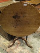 A 19th Century mahogany circular tilt top occasional table raised on turned and ringed column to