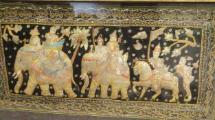 A large Burmese relief wall hanging depicting figures on elephants and horse back set sequins on a