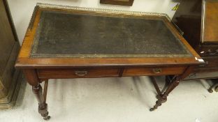 A mahogany two drawer leather topped desk with brass three quarter galleried top rail,