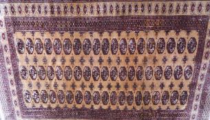 A Bokhara rug, the repeating elephant foot medallions in burgundy,