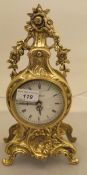 A modern brass cased mantel clock in the Rococo taste,