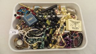 A tray containing a collection of costume jewellery, to include necklaces, earrings, wristwatch,