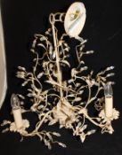 A pair of three branch electroliers with painted metal intertwined branches and cut glass flower