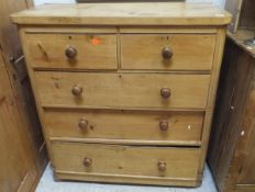 A Victorian pine chest of two short and three long graduated drawers on turned feet