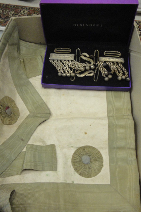 A box containing Masonic aprons and attachments,
