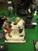 A reproduction cast iron boxing money bank depicting two boxers in a boxing ring,