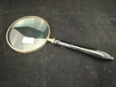 A large magnifying glass with ebonised handle*