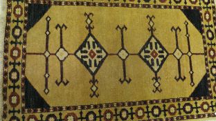 A Caucasian rug, the two central diamond-shaped medallions in blue,