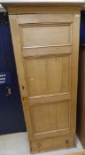 A Victorian pine single door cupboard enclosing hanging space above a single drawer to plinth base