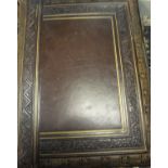 A circa 1900 gilded and embossed leather photograph album containing various family photographs