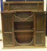 A circa 1900 carved oak wall cupboard,