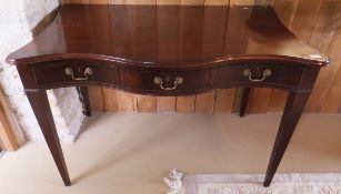 A 19th Century mahogany serpentine fronted writing table with three frieze drawers,
