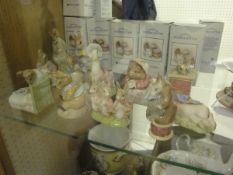 A collection of twelve Royal Albert Beatrix Potter figures to include "Peter in the gooseberry net",