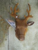 A cast metal garden ornament of a deer's head*