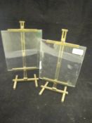 A pair of photograph frames in the form of artist's easels with adjustable lacquered brass frames