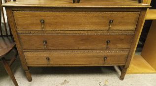 A early 20th Century oak chest of three long drawers raised on turned and ring legs together with a