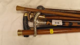 Two gold topped evening canes, two silver topped canes,