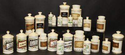 A large collection of ceramic and glass chemist's jars bearing labels / inscriptions to include