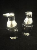 A pair of stainless steel cocktail shakers in the form of penguins*