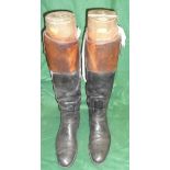 A pair of black and tan hunting boots with wooden trees bearing ivory plaques inscribed "Maxwell,