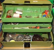 A cantilever tackle box containing a quantity of reels, floats,